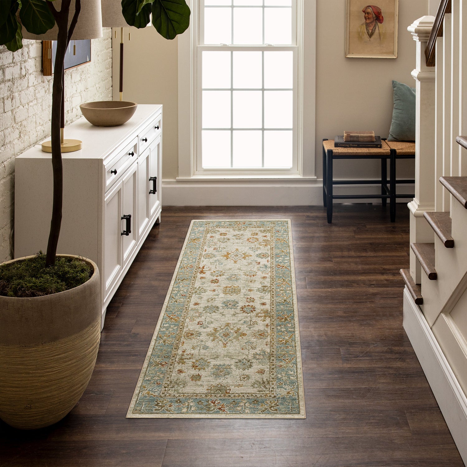 Floral abstract area rug with orange chair 